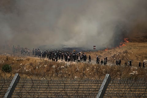 Syrian Druze protest on the Syrian side of the border with Israel, in Majdal Shams in the Israeli-controlled Golan Heights, Wednesday, July 16, 2025.