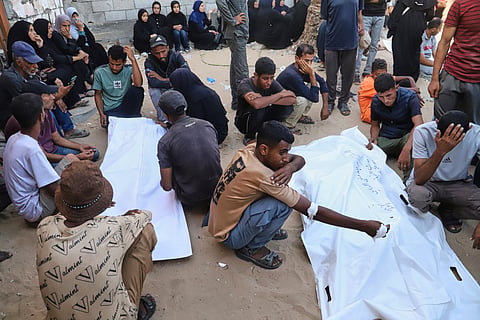 Relatives of Palestinians killed at an aid distribution center run by the Gaza Humanitarian Foundation, a U.S.-backed organization approved by Israel, mourn over their bodies during their funeral at Nasser Hospital in Khan Younis, southern Gaza Strip, Saturday, July 19, 2025.
