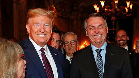 Former Brazil's President Jair Bolsonaro, right, stands with President Donald Trump during a dinner at Mar-a-Lago, Palm Beach, Fla., March 7, 2020