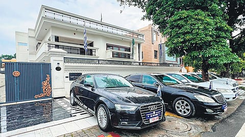 Luxury cars bearing fake diplomatic number plates in front of the illegal embassy in Kavinagar, Ghaziabad, Uttar Pradesh. Inset: Fake diplomat Harsh Vardhan Jain