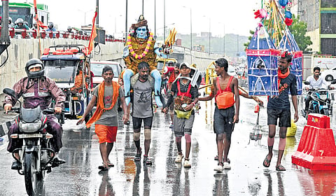 Kanwariyas carry the holy water of river Ganga for Lord Shivas worship during their pilgrimage in the month of Shravan, in New Delhi, Tuesday, July 22, 2025.