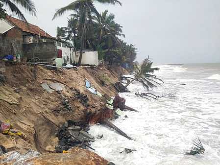Increasing sea erosion damaging houses in Puthenthurai coastal village in Kanniyakumari district on Thursday.