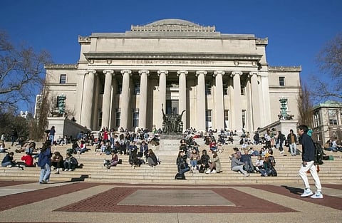 Students sit on the front steps of Low Memorial Library on the Columbia University campus in New York City, Feb. 10, 2023. 