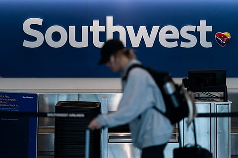 A traveler walks through the Southwest Airlines ticketing counter area at the Los Angeles International Airport in Los Angeles, April 18, 2023. 