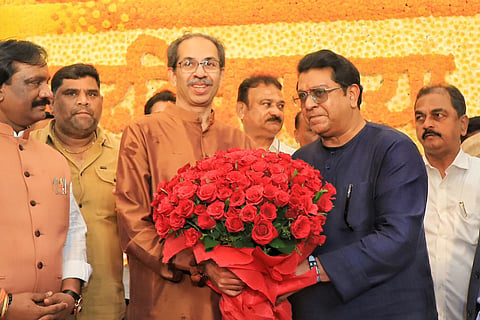 MNS chief Raj Thackeray presents a bouquet of red roses to his cousin and Shiv Sena (UBT) leader Uddhav Thackeray at Matoshree on the latter’s 65th birthday.