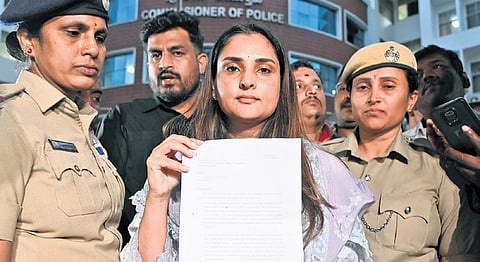 Ramya shows her petition submitted to the police commissioner 
on Monday 
