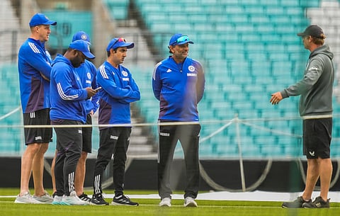 Indian support staff conversing with the groundstaff at The Oval on Tuesday 