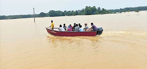 Villagers on way to Baliapal chowk on boat in Balasore district on Monday.`