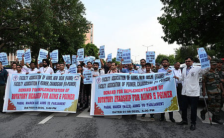 Faculty members of AIIMS holding a protest march to parliament with a demand to implement rotatory headship,in New Delhi on Friday.Express Photo by