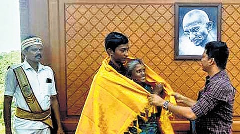 Collector NO Sukhaputhra congratulating the boy and his mother 
