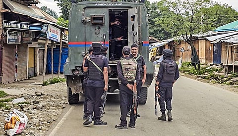 Security personnel keep a vigil amid an ongoing encounter between security forces and terrorists in a forest area at Akhal, in Kulgam district.
