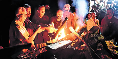M S Renjith and M S Harris, sons of M K Sanoo, light the pyre at Ravipuram crematorium 