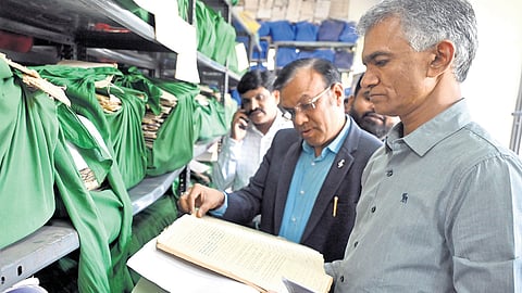 Revenue Minister Krishna Byre Gowda inspects documents after launching the 
‘Bhoo Suraksha’ scheme in Bengaluru on Tuesday 