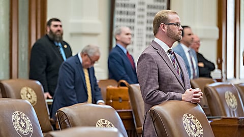 Texas House Rep. Daniel Alders, R - Tyler, stands at his desk during with empty chairs belonging to House Democrats remain empty in the State Capitol, Tuesday, Aug. 5, 2025, in Austin, Texas. 