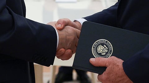 Russian President Vladimir Putin, left, and US special envoy Steve Witkoff, right, shake hands during their meeting at the Kremlin in Moscow, Russia, Wednesday, Aug. 6, 2025. 