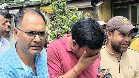 Bhupendra Panwar, owner of a homestay that was washed away in  Uttarkashi deluge being consoled by the villagers.