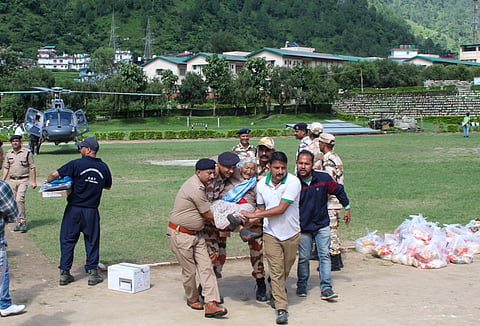  A senior citizen rescued from flood-hit Dharali being brought to ITBP Matli Helipad, in Uttarkashi, Thursday, Aug. 7, 2025. 