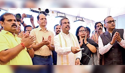 Union Education minister Dharmendra Pradhan, flanked by MPs Pradeep Panigrahy and Anita Subhadarshini, inaugurates the plant.