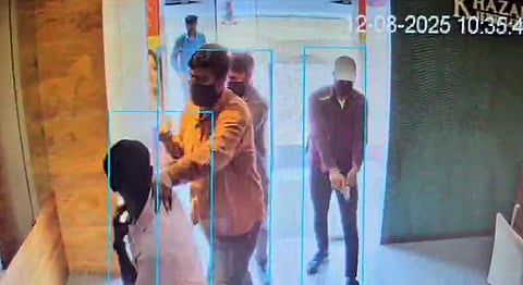 Screengrab of the robbers barging into the Khazana Jewellery store at Chandanagar in Hyderabad on Tuesday 