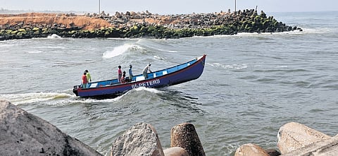 A fishing boat passing through Muthalapozhi harbour mouth at Perumathura in Thiruvananthapuram 