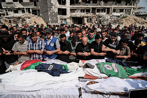 Palestinians pray over the bodies of journalists, including Al Jazeera correspondents Anas al-Sharif and Mohamed Qreiqeh, who were killed in an Israeli airstrike, during their funeral outside Gaza City's Shifa hospital complex, Monday, Aug. 11, 2025. 