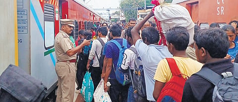 Passengers rush to board KSR  Bengaluru - Kanyakumari Express at T’Puram Central Railway Station on Sunday 