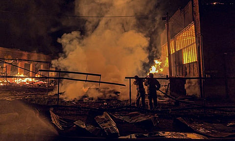 This handout photograph taken and released by the Ukrainian Emergency Service on August 20, 2025, shows Ukrainian emergency workers in action following an air attack, in Okhtyrka, Sumy region, amid the Russian invasion of Ukraine.