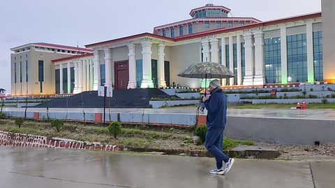 Uttarakhand Chief Minister Pushkar Singh Dhami taking a morning stroll with an umbrella in the rain near the Bhararisain Assembly building in Gairsain.