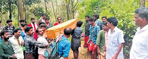 Tribal residents carrying the body of five-year-old Karthik in a coffin from Anakkulam to Koodalarkudi, Idukki, on Saturday 