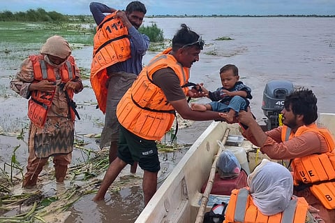 In this photo released by Pakistan's National Disaster Management Authority, rescue workers evacuate villagers from a low-lying area due to rising water level in the Sutlej River following neighbouring India released water from overflowing dams, in Bahawalnagar a district in Pakistan's Punjab province bordering India, Tuesday, Aug. 26, 2025.