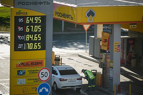 A gas station worker refuels a car in Moscow, Russia, on Aug. 25, 2025.