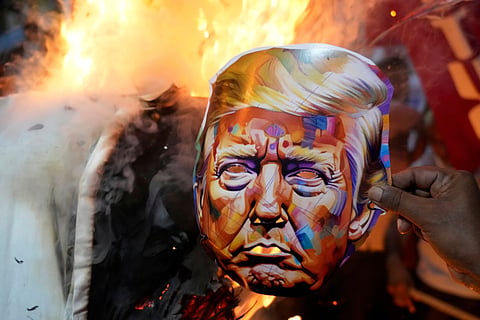 Activists of different trade unions and farmer's organizations burn an effigy of the U.S. President Donald Trump, near the American Consulate during a protest rally on trade tariffs and the war in Gaza in Kolkata, India, Wednesday, Aug. 13, 2025. 