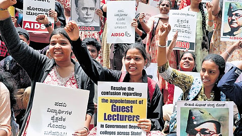 AIDSO members hold placards demanding immediate appointment of guest faculty at government colleges during a stir at Freedom Park on Friday 