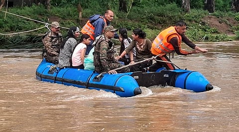 Indian army rescuing stranded people to safer areas.