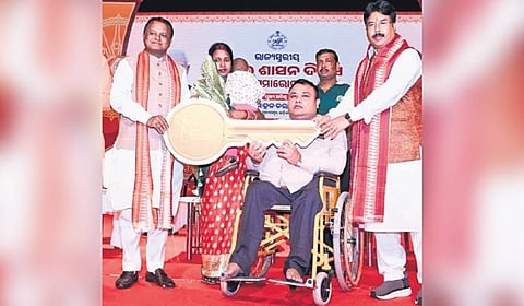 CM Mohan Majhi handing over key to a beneficiary of affordable housing scheme.