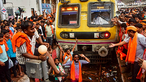Maratha community members stop a train during their protest seeking reservation for the community under the Other Backward Classes (OBC) category, at Chhatrapati Shivaji Maharaj Terminus (CSMT) in Mumbai