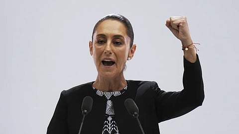 Mexican President Claudia Sheinbaum raises her fist at the end of her first state-of-the-nation address at the National Palace in Mexico City, Monday, Sept. 1, 2025.