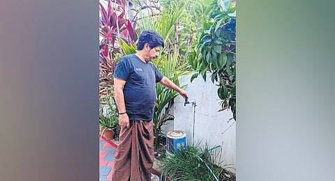 Vayalar Madhavankutty, a resident of Sasthamangalam, showing the 
dried-up water