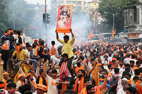Maratha community members celebrate after the Maharashtra government accepted most of activist Manoj Jarange Patil's demands, including granting eligible Marathas Kunbi caste certificates which will make them eligible for reservation benefits available to OBCs, in Mumbai, Tuesday, Sept. 2, 2025.