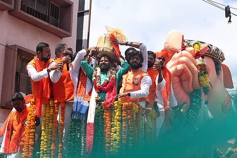 Lingala Dasrath Goud of Karmanghat carries the 'Balapur Ganesh Laddu' on his head after winning the open auction with a successful bid of Rs 35 lakhs at Balapur on Saturday. 