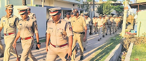 Police take out a route march on Monday morning, a day after the violence in Maddur, Mandya district.