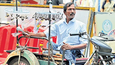 A differently abled person sells lottery in front of Sree Padmanabhaswamy Temple in Thiruvananthapuram on Tuesday 