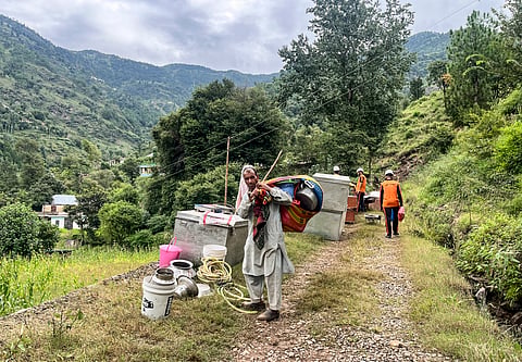 People move to safer locations after land sinking at Kalaban area of Mendhar, in Poonch district, Jammu and Kashmir, Tuesday, Sept. 9, 2025.