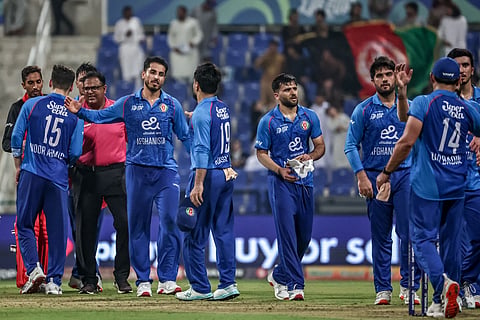 Afghanistan's players celebrate after winning the Asia Cup 2025 Twenty20 international cricket match between Afghanistan and Hong Kong at the Sheikh Zayed Cricket Stadium in Abu Dhabi on September 9, 2025. 