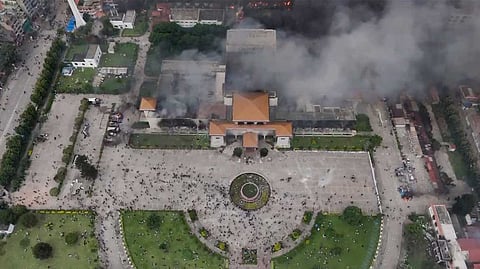 Smoke billows out after Nepal's Parliament building was set on fire by agitators amid massive anti-government protests, in Kathmandu, Nepal, Tuesday, Sept. 9, 2025.