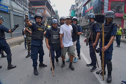 Policemen arrest a prisoner who escaped from Dilli Bazaar jail in Kathmandu, Nepal, Wednesday, Sept. 10, 2025.