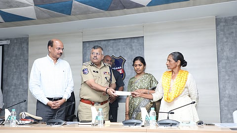 DGP Dr Jitender handing over Rs 25 cash prize and additional benefits under the Telangana state's rehabilitation schemes to former CPI (Maoist) leader Pothula Padmavathi on Saturday.