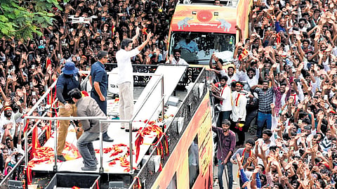 TVK leader Vijay greeting a crowd of his supporters at his first campaign rally in Tiruchy on Saturday 