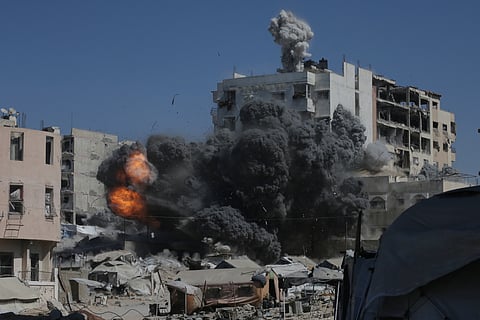 Smoke and flames rise after an Israeli military strike on a building in Gaza City, Friday, Sept. 12, 2025.