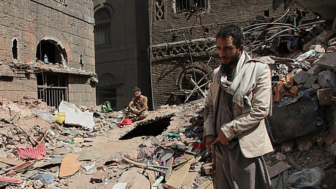 Two Yemeni men inspect the rubble of a house that was destroyed in Wednesday's Israeli airstrikes, in Sanaa, Yemen, Saturday, Sept. 13, 2025.